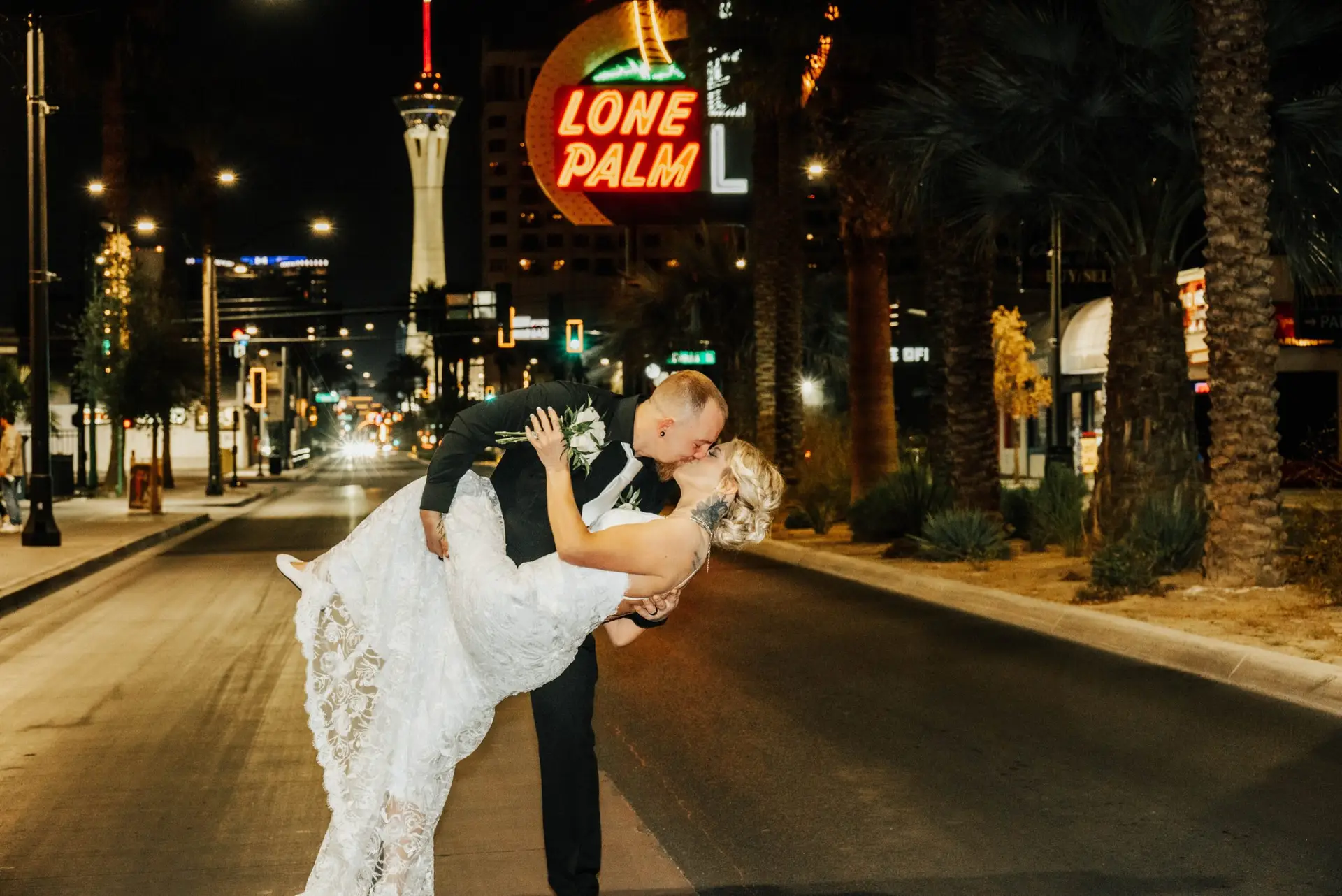 Bride and groom eloping under neon lights at a Las Vegas wedding chapel