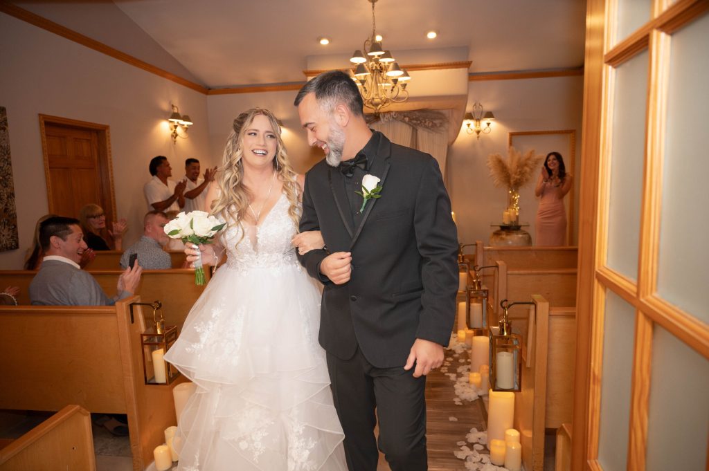 Bride and groom laughing together during candid wedding photography
