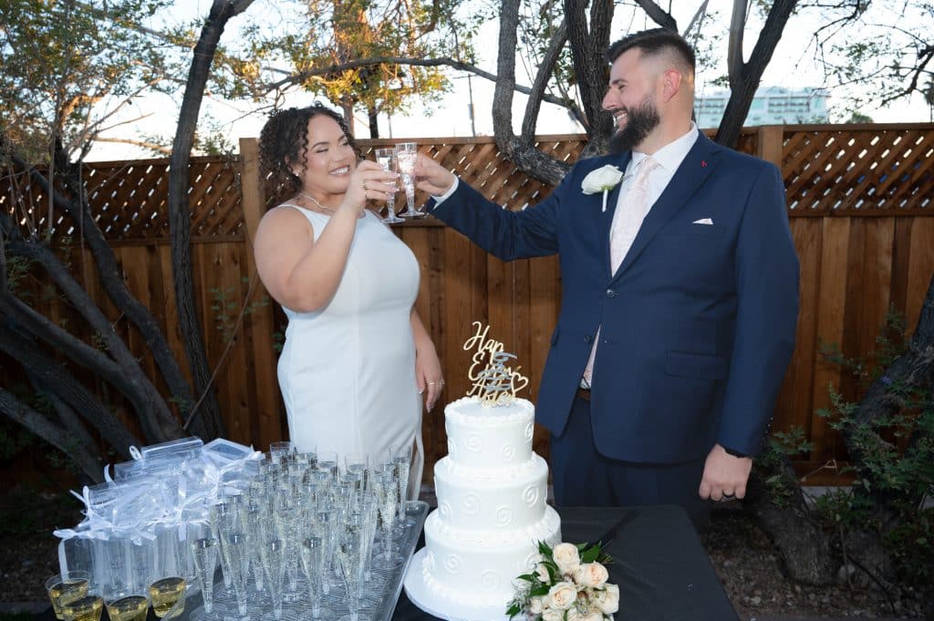 bride and groom toast and cut wedding cake in Las Vegas
